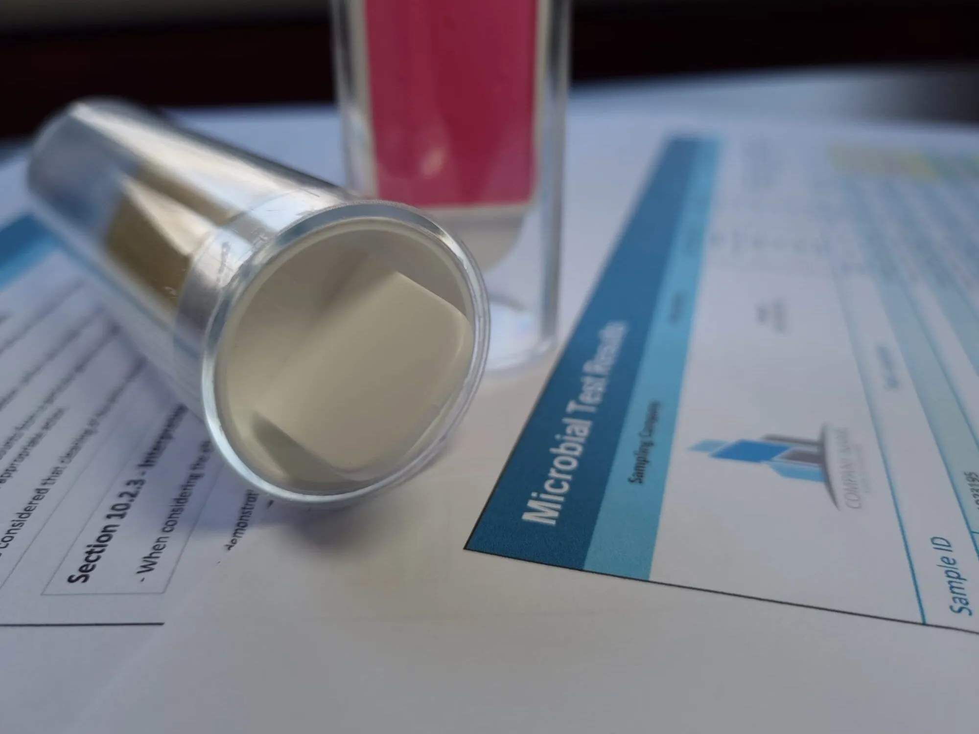 A microbiological dip slide on a results sheet